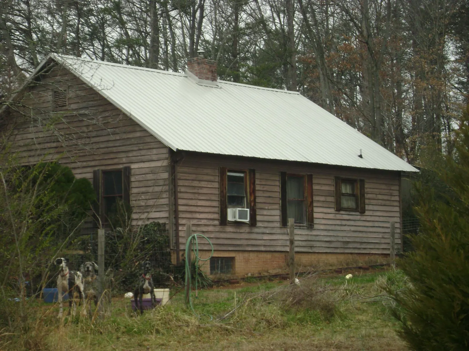 White metal roof on an old wood sided farmhouse, from a Metal Roof Installation job in Lincroft